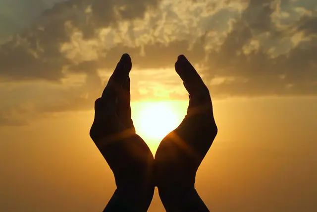 Cupped hands around the sun